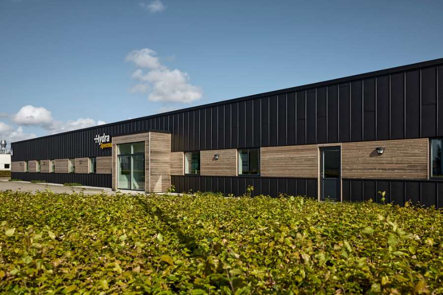 Black steel profiles and warm wood create striking contrasts on headquarters facade, Jernvej 19, 6900 Skjern, Denmark
